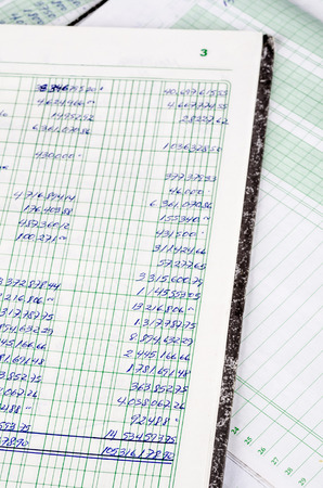 Handwritten accounting on the open pages of some old ledgersの写真素材