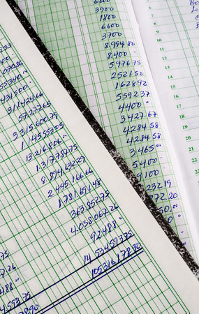 Handwritten accounting on the open pages of some old ledgersの写真素材