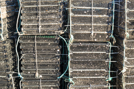 Piles of cages as used for fish farmingの写真素材