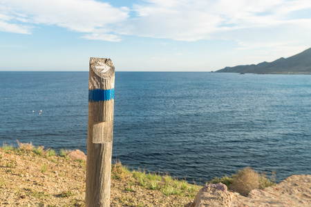 Wooden hiking guidepost against the background  of the coastの写真素材