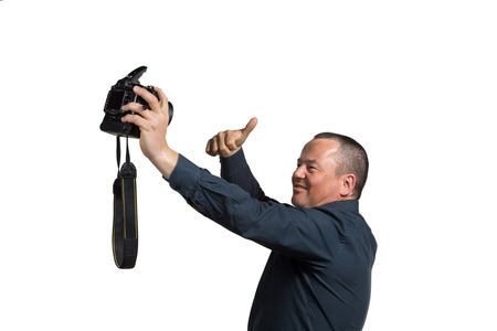 Guy in his 40s fooling around with too big a camera for a selfie