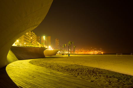 Benidorm beach resort town shot at night from one of its sandy beachesの写真素材