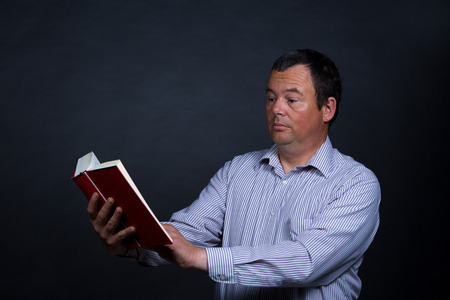 Man finding it increasingly difficult to read without glassesの写真素材