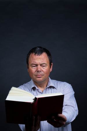 Man finding it increasingly difficult to read without glassesの写真素材