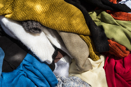 Pile of second hand clothes on a street marketの写真素材