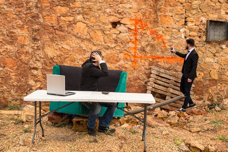 A bearish chart being drawn with graffiti on a ruin wall, a financial crisis conceptの写真素材