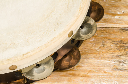 Closeup take of a tambourine on a wooden tableの写真素材