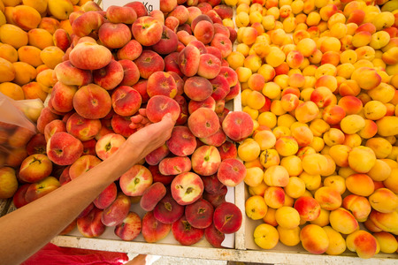 Fresh apricots and peaches on a street market stallの写真素材