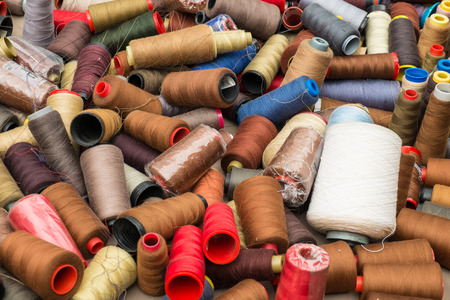 Lots of yarn spools on a street market stall