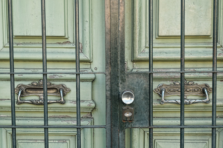 Detail take of an old wooden door with beautiful brass handles