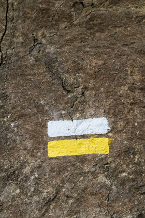 Sign  painted on a rock to mark the way for hikersの写真素材