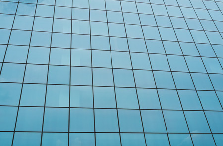 Full frame take of the mirrored facade of a corporate building