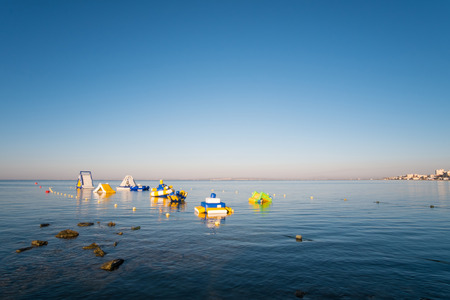 Inflatable slides and jumping castles at a beach resortの写真素材