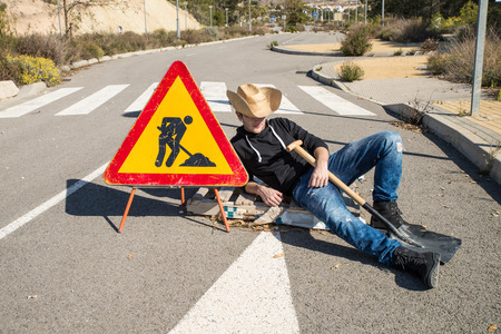 Lazy guy on a  road works site, a concept