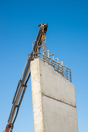 Heavy crane removing encasement from finished concrete wall