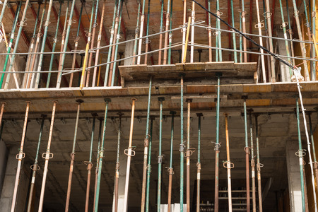 Construction props supporting an unfinished concrete structure
