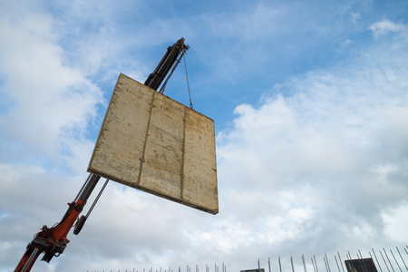 Crane lifting the encasement of a concrete panelの写真素材