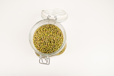 Jar with open lid full of soy beans