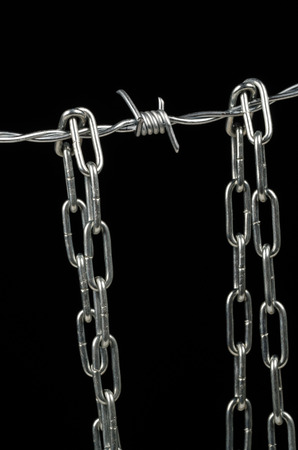 Barbed wire and chain, a human rights and immigration conceptの写真素材