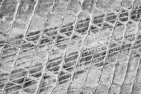 Fresh tire marks on a cobblestone street
