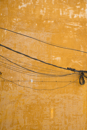 Dangerous electricity wiring on an old house facadeの写真素材