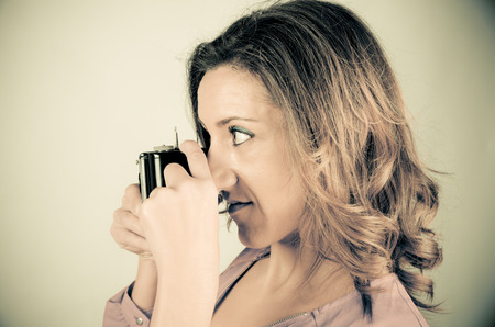 Female photographer using a retro  camera from the 1920sの写真素材