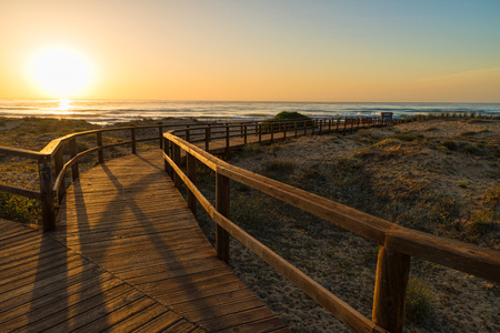 Wooden walkway down to a sandy beach with dunes on Costa Blanca, Alicante, Spainの写真素材
