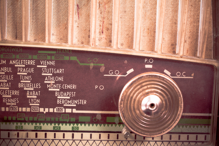 Detail take of a vintage radio receiver dial with the names of different cities on itの写真素材