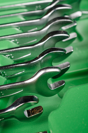 Wrenches assorted by size inside a tool boxの写真素材