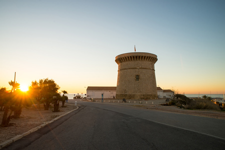 Sunrise over the landmark watchtower in Campello, Costa Blanca, Spainの写真素材