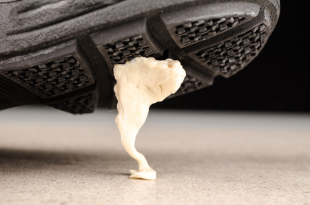 Chewing gum stuck to a shoe sole, a conceptの写真素材