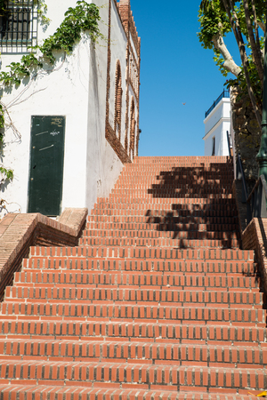 Andalusian village street with a steep terracota staircase