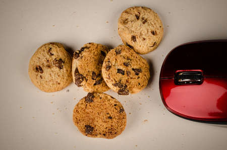 Mouse eating cookies, a funny technology concept