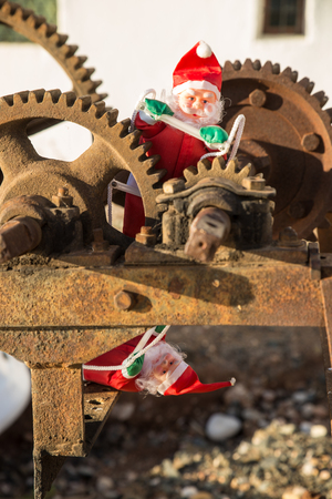 Santa in the cogwheels of consumerism, a conceptの写真素材
