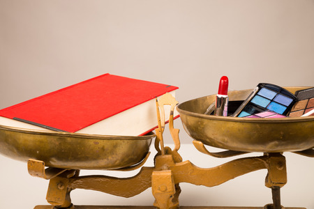 Make up and a book on some vintage scales, a conceptの写真素材