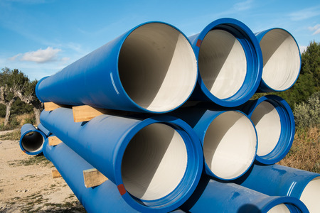 Stacked natural gas pipes waiting to be usedの写真素材