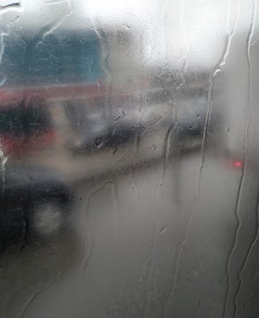 Road view from the bus window on a rainy dayの写真素材