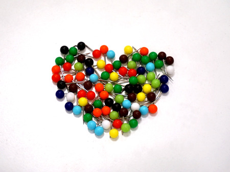 Multicolored Push Pins  for office use place on the white desk background.の写真素材