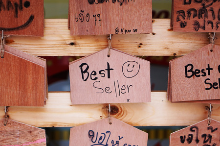 Wooden sign shop selling books, greeting customers in the restaurant opening.の写真素材