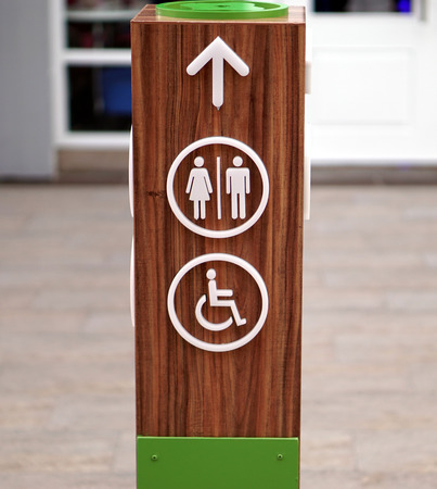 Public restroom signs with a disabled access symbolの写真素材