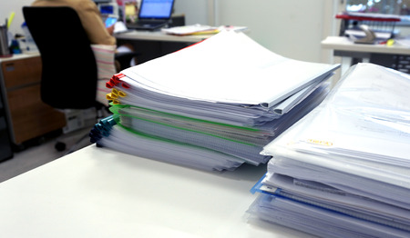 The documents and folders consists of multicolored plastic ridge, blue, yellow, red and green on the...