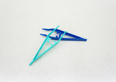Blue and Green medical forceps  on the white background