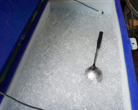 The scoop was place  in the tube shape ice containerの写真素材