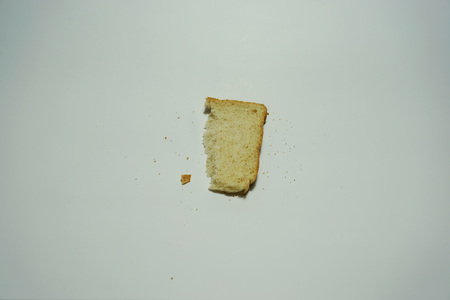 Half of slice wheat bread  on white backgroundの写真素材