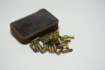 Many bullets .22 mm with a leather case on white backgroundの写真素材