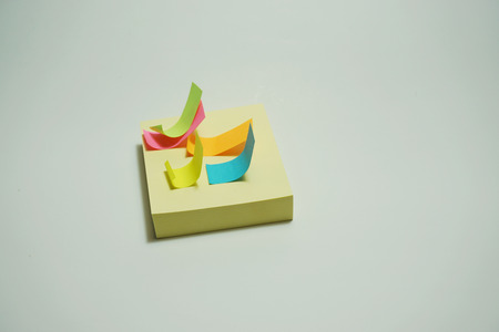 Yellow and multicolor stick note on white background