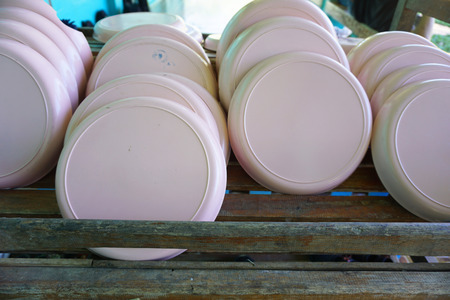 Plastic plate on wooden shelf after clean in schoolの写真素材