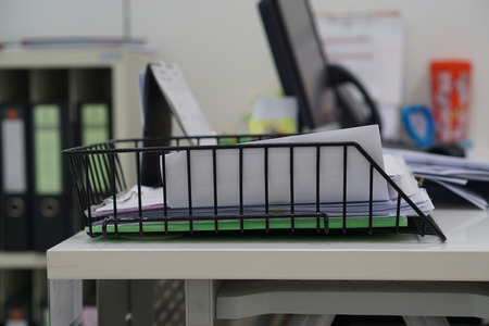 Document tray with document white paper on desk in office. Business office concept.
