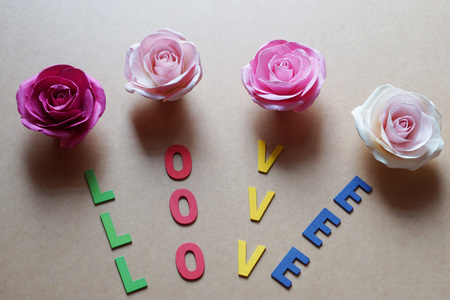 Rose and Love word pattern from wood letter on brown paper background.                     の写真素材