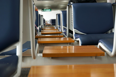   Small wooden tables and blue chairs background  in the airport of Thailand.                                       の写真素材